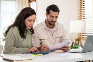 Couple reviewing finances at their laptop