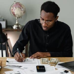 Man sitting at desk reviewing financial documents