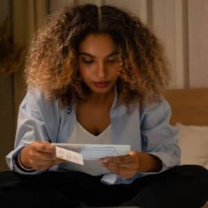 woman carefully reviewing her bills